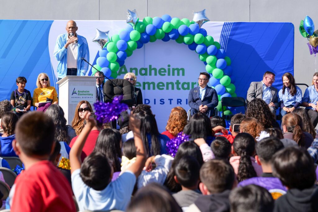 NBA icon Kareem Abdul-Jabbar shares words of encouragement with Edison Elementary students during an outdoor assembly celebrating the launch of a new partnership between the Skyhook Foundation and OCDE’s Inside the Outdoors.