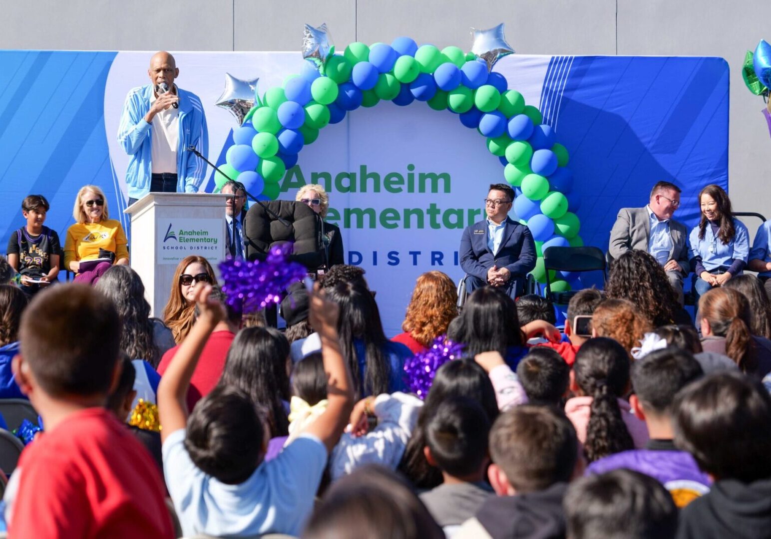 NBA icon Kareem Abdul-Jabbar shares words of encouragement with Edison Elementary students during an outdoor assembly celebrating the launch of a new partnership between the Skyhook Foundation and OCDE’s Inside the Outdoors.